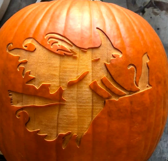A pumpkin laser-engraved with a witch flying on a broomstick